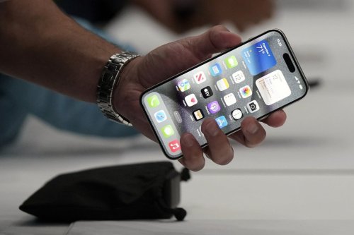 A person holds an iPhone 15 Pro at the Apple campus, Sept. 12, 2023, in Cupertino, Calif. (AP Photo/Jeff Chiu, File)