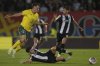 Hibernian's Josh Mulligan, left, duels for the ball with Partizan's Milan Vukotic during a UEFA Conference League third qualifying round, first leg soccer match between Partizan and Hibernian, at the Partizan stadium, in Belgrade, Serbia, Thursday, Aug. 7, 2025. (AP Photo/Darko Vojinovic)