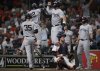 New York Yankees' Trent Grisham (12) celebrates with designated hitter Aaron Judge, top center, after hitting a grand slam during the fifth inning of a baseball game against the Houston Astros in Houston, Tuesday, Sept. 2, 2025. Paul Goldschmidt, Cody Bellinger, and Aaron Judge also scored. (AP Photo/Ashley Landis)