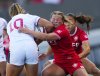 Canada's Claire Gallagher (10), second from right, tackles USA's McKenzie Hawkins (10) during the first half of Women's rugby action in Ottawa on Friday, Aug. 1, 2025. THE CANADIAN PRESS/Sean Kilpatrick