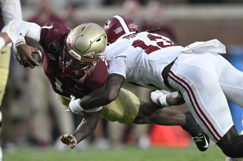 Florida State quarterback Tommy Castellanos (1) dives for extra yardage as Alabama defensive back Zavier Mincey (12) makes the tackle during the second half of an NCAA college football game, Saturday, Aug. 30, 2025, in Tallahassee, Fla. (AP Photo/Phelan M. Ebenhack)