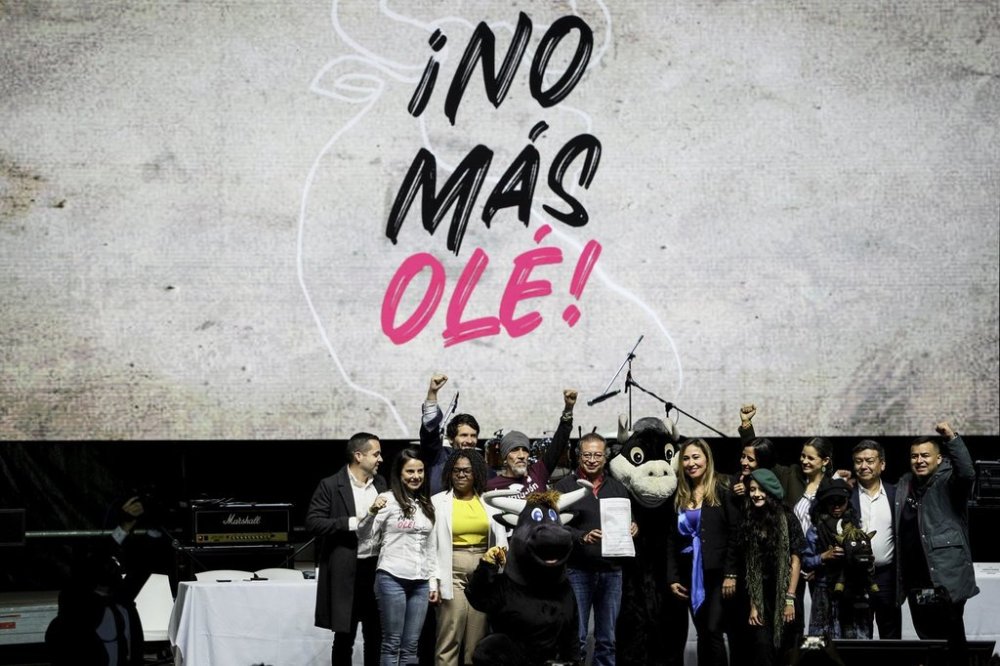 FILE - Colombian President Gustavo Petro holds up a law that bans bullfighting, in La Plaza Santa Maria, Bogota, Colombia, July 22, 2024. (AP Photo/Ivan Valencia, File)