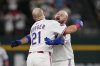 Texas Rangers' Jake Burger (21) and Rowdy Tellez, right, celebrate Burger's run-scoring single in the 10th inning of a baseball game against the Arizona Diamondbacks Monday, Aug. 11, 2025, in Arlington, Texas. (AP Photo/Tony Gutierrez)