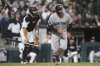 New York Yankees' Trent Grisham, right, watches his two-run home run during the eighth inning of a baseball game against the Chicago White Sox in Chicago, Thursday, Aug. 28, 2025. (AP Photo/Nam Y. Huh)