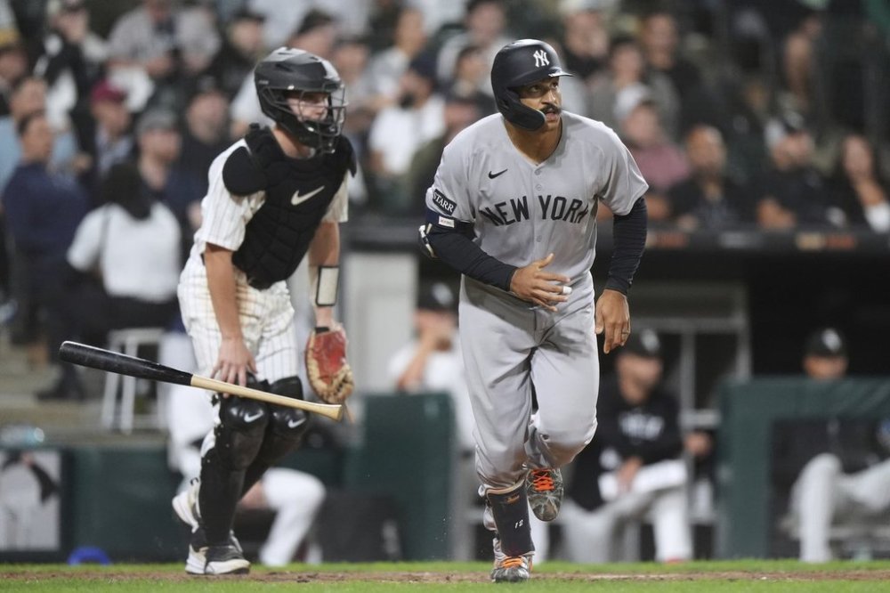 New York Yankees' Trent Grisham, right, watches his two-run home run during the eighth inning of a baseball game against the Chicago White Sox in Chicago, Thursday, Aug. 28, 2025. (AP Photo/Nam Y. Huh)