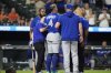 Toronto Blue Jays' George Springer (4) is helped by trainers after being hit by a pitch by Baltimore Orioles reliever Kade Strowd during the ninth inning of a baseball game, Monday, July 28, 2025, in Baltimore. (AP Photo/Stephanie Scarbrough)