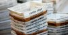 FILE- In this Dec. 14, 2017, file photo, boxes for sorted mail are stacked at the main post office in Omaha, Neb. (AP Photo/Nati Harnik, File)