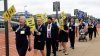 PSA Airlines flight attendants hold placards during a demonstration at Ronald Reagan Washington National Airport, Monday, August 18, 2025, in Washington. (AP Photo/Rahmat Gul)