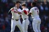 Cleveland Guardians' Kyle Manzardo, center, is congratulated by Angel Martinez, right, and Nolan Jones, left, after driving in the game winning run in the 10th inning of a baseball game against the Tampa Bay Rays, Wednesday, Aug. 27, 2025, in Cleveland. (AP Photo/David Dermer)