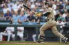 San Diego Padres' Ramon Laureano follows through on a grand slam against the Seattle Mariners during the first inning of a baseball game Tuesday, Aug. 26, 2025, in Seattle. (AP Photo/Lindsey Wasson)