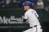 Texas Rangers' Corey Seager follows through on a single in the first inning of a baseball game against the Los Angeles Angels, Wednesday, Aug. 27, 2025, in Arlington, Texas. (AP Photo/Tony Gutierrez)