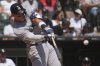 New York Yankees' Aaron Judge hits a solo home run during the first inning of a baseball game against the Chicago White Sox in Chicago, Sunday, Aug. 31, 2025. (AP Photo/Nam Y. Huh)