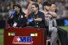 San Francisco Giants starting pitcher Landen Roupp, second from right, is taken out in a cart after being hit by a line drive during the third inning of a baseball game against the San Diego Padres Wednesday, Aug. 20, 2025, in San Diego. (AP Photo/Orlando Ramirez)