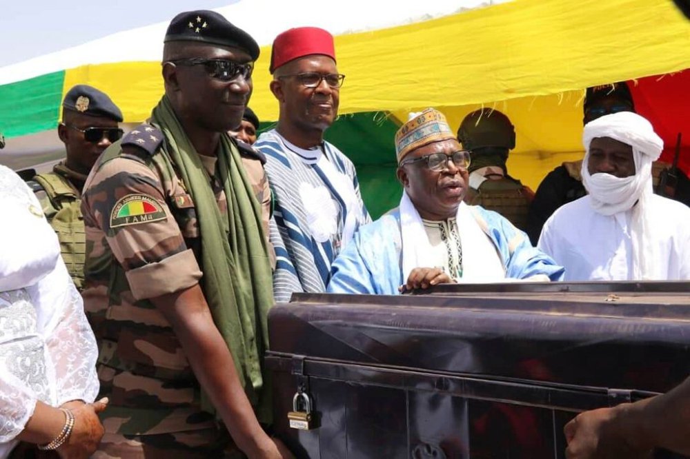 Members of the Malian government return boxes containing ancient Timbuktu manuscripts to the community elders in Timbuktu, Mali, Monday, Aug. 11, 2025. (AP Photo/Moulaye Sayah)