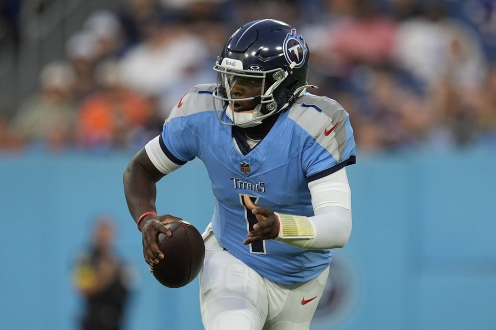 Tennessee Titans quarterback Cam Ward (1) scrambles against the Minnesota Vikings during the first half of a preseason NFL football game, Friday, Aug. 22, 2025, in Nashville, Tenn. (AP Photo/George Walker IV)