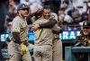San Diego Padres' Manny Machado hugs teammate Jose Iglesias (7) after he hit a two-run homerun in the second inning of a baseball game against the San Francisco Giants at Oracle Park in San Francisco, on Tuesday, Aug. 12, 2025. (Carlos Avila Gonzalez/San Francisco Chronicle via AP)