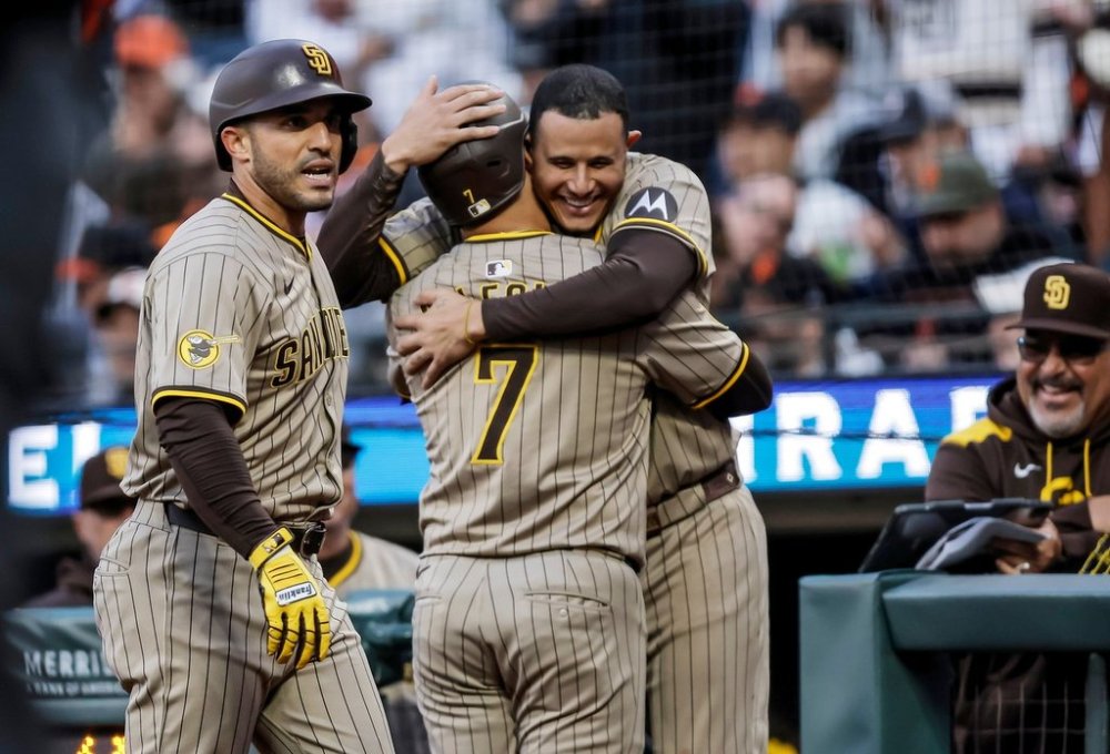 San Diego Padres' Manny Machado hugs teammate Jose Iglesias (7) after he hit a two-run homerun in the second inning of a baseball game against the San Francisco Giants at Oracle Park in San Francisco, on Tuesday, Aug. 12, 2025. (Carlos Avila Gonzalez/San Francisco Chronicle via AP)