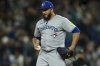 Toronto Blue Jays relief pitcher Yimi Garcia reacts after throwing a wild pitch during the eighth inning of a baseball game against the Seattle Mariners, Friday, May 9, 2025, in Seattle. (AP Photo/Rio Giancarlo)