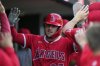 Los Angeles Angels designated hitter Mike Trout celebrates in the dugout after scoring off a double hit by Taylor Ward during the first inning of a baseball game against the Detroit Tigers, Saturday, Aug. 9, 2025, in Detroit. (AP Photo/Ryan Sun)