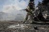FILE - In this photo provided by Ukraine's 24th Mechanized Brigade press service, a firefighter puts out a fire after a Russian drone hit a market in the town of Druzhkivka, Donetsk region, Ukraine, Saturday, Aug. 2, 2025, (Oleg Petrasiuk/Ukraine's 24th Mechanized Brigade via AP, File)