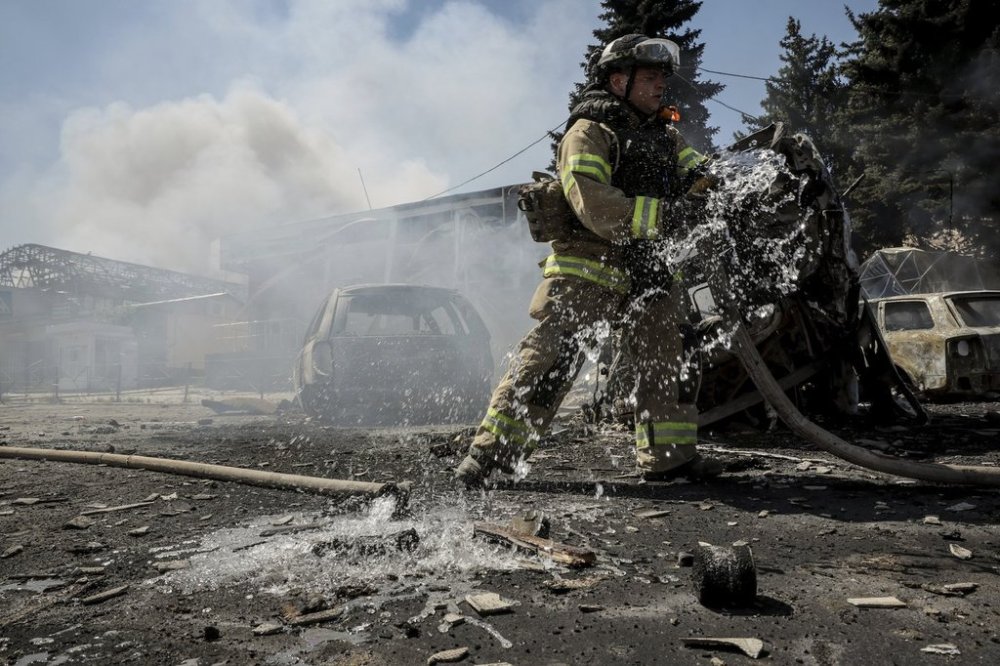 FILE - In this photo provided by Ukraine's 24th Mechanized Brigade press service, a firefighter puts out a fire after a Russian drone hit a market in the town of Druzhkivka, Donetsk region, Ukraine, Saturday, Aug. 2, 2025, (Oleg Petrasiuk/Ukraine's 24th Mechanized Brigade via AP, File)