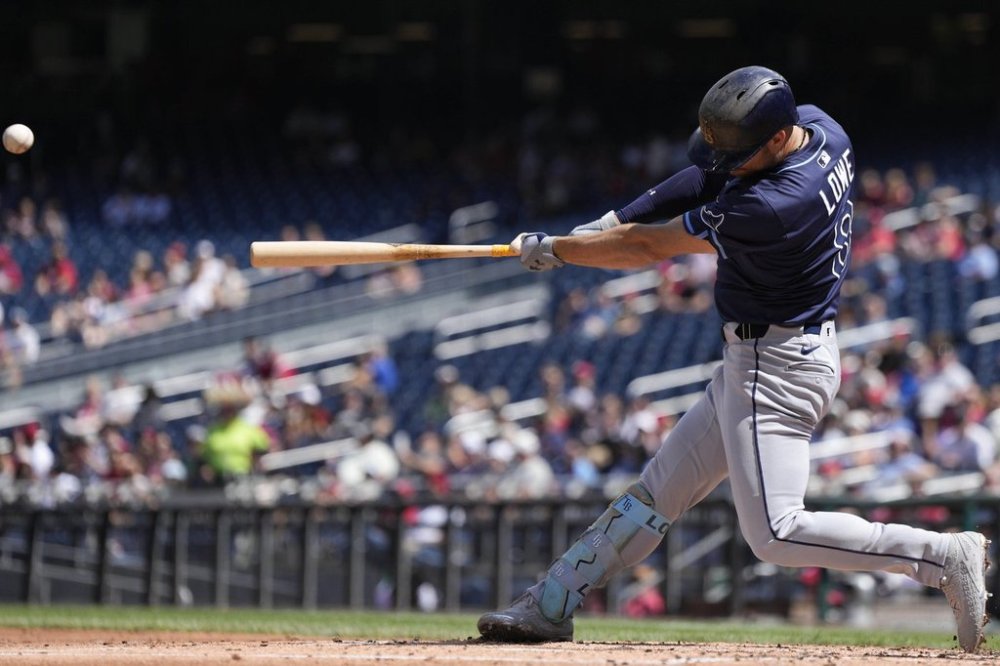 Tampa Bay Rays designated hitter Brandon Lowe hits a grand slam against the Washington Nationals during the second inning of a baseball game at Nationals Park, Sunday, Aug. 31, 2025, in Washington. (AP Photo/Jess Rapfogel)