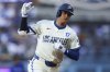Los Angeles Dodgers' Shohei Ohtani gestures while running the bases after hitting a home run during the fifth inning of a baseball game against the Toronto Blue Jays, Saturday, Aug. 9, 2025, in Los Angeles. (AP Photo/Jessie Alcheh)
