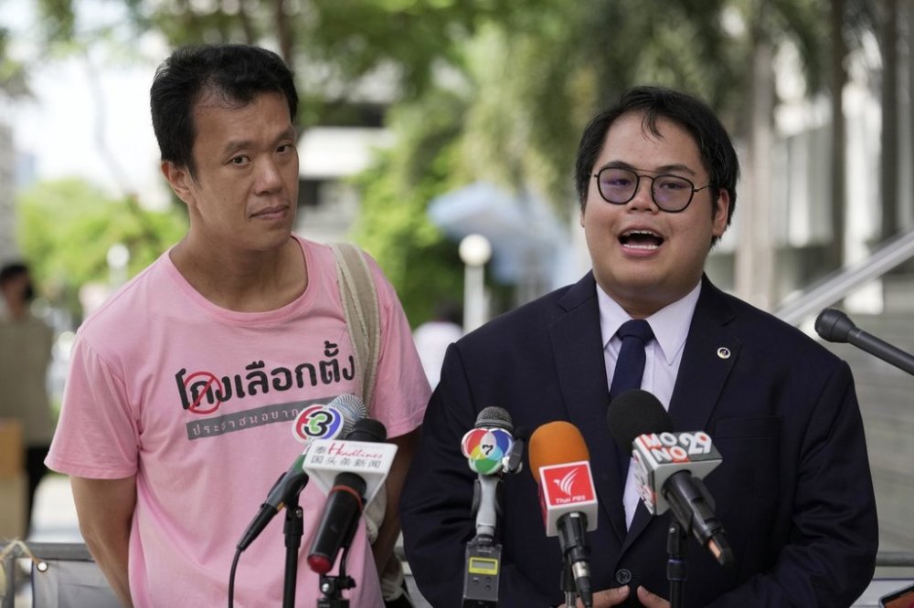 FILE - Student activist Bunkueanun Paothong, right, with activist Ekachai Hongkangwan talks to reporters before leaving a criminal court in Bangkok, Thailand, Wednesday, June 28, 2023. (AP Photo/Sakchai Lalit, file)
