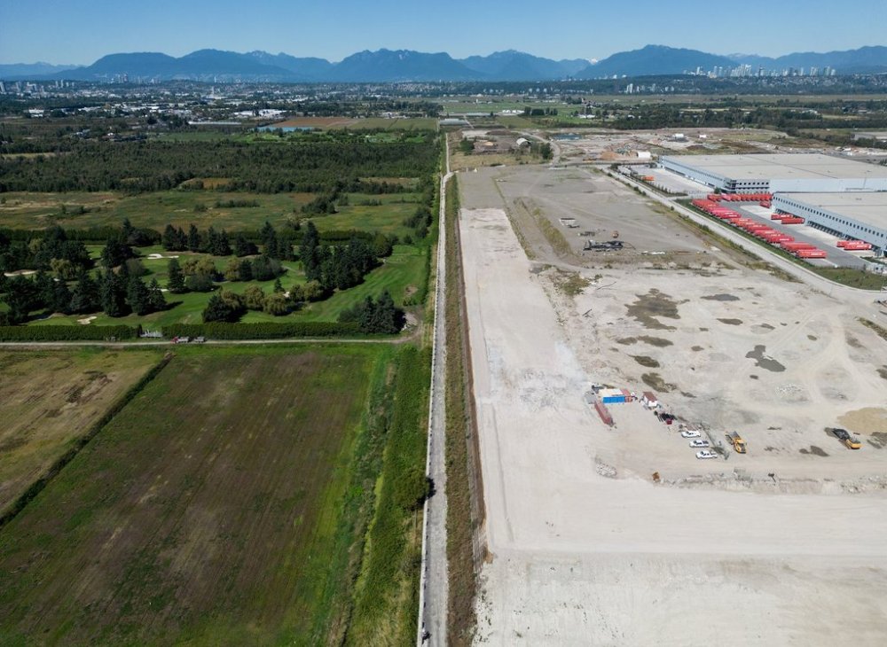 Farmland and Country Meadows Golf Course, left and industrial lands, right, that include a Canadian Tire distribution centre, which fall within the boundaries of a Cowichan Nation Aboriginal title claim, are seen in an aerial view in Richmond, B.C., on Friday, August 22, 2025. THE CANADIAN PRESS/Darryl Dyck