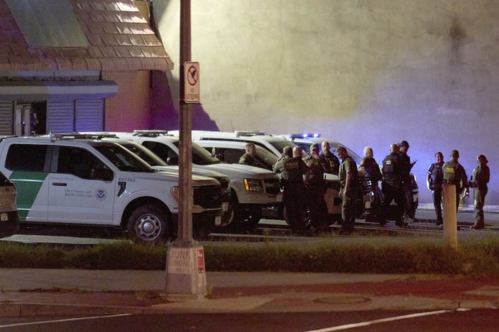 Agents with U.S. Customs and Border Protection as well as Metropolitan Police wait in a parking lot before driving along Kennedy Street NW in a caravan, in the early morning of Wednesday, Aug. 13, 2025, in northwest Washington. (AP Photo/Jacquelyn Martin)