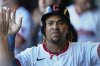 Cleveland Guardians' Jose Ramirez is congratulated in the dugout after scoring in the first inning of a baseball game against the Miami Marlins in Cleveland, Thursday, Aug. 14, 2025. (AP Photo/Sue Ogrocki)
