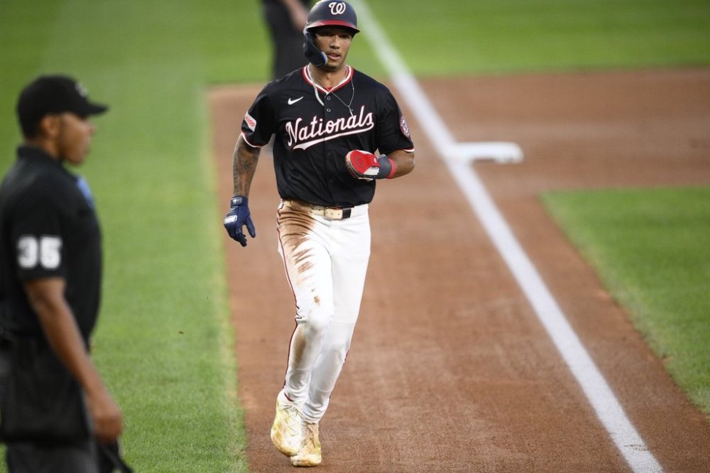Washington Nationals' Daylen Lile runs home to score on a double by Riley Adams during the second inning of a baseball game against the Miami Marlins, Tuesday, Sept. 2, 2025, in Washington. (AP Photo/Nick Wass)
