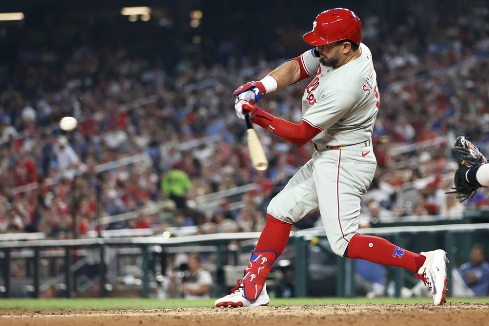 Philadelphia Phillies' Kyle Schwarber hits a home run during the seventh inning of a baseball game against the Washington Nationals, Friday, Aug. 15, 2025, in Washington. (AP Photo/Daniel Kucin Jr.)