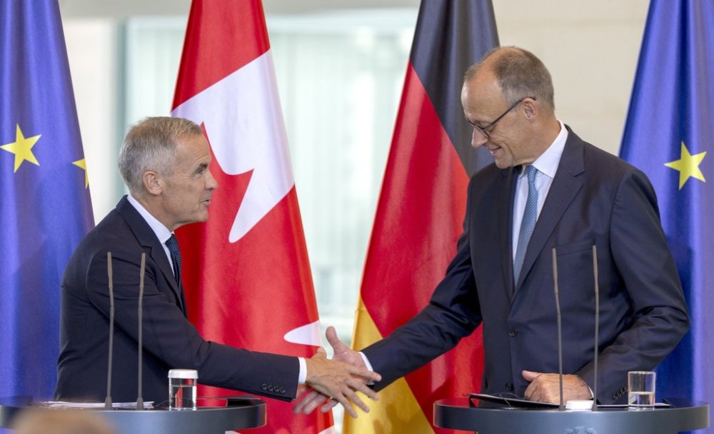 Prime Minister Mark Carney, left and German Chancellor Friedrich Merz shake hands following a joint media availability at the Federal Chancellery in Berlin, Germany on Tuesday, Aug. 26, 2025. THE CANADIAN PRESS/Christinne Muschi