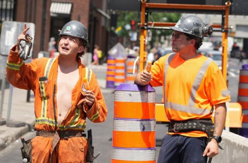 Construction workers eat popsicles on their worksite in downtown Montreal on Tuesday, June 18, 2024. THE CANADIAN PRESS/Christinne Muschi