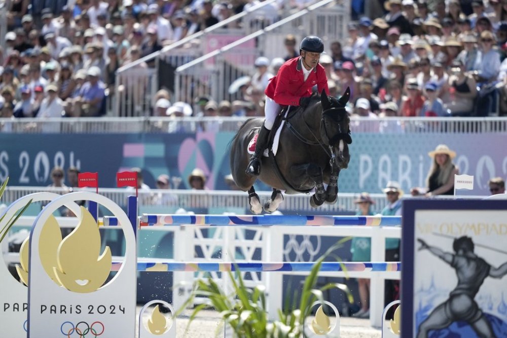 FILE - Switzerland's Pius Schwizer, riding Vancouver de Lanlore, during the Equestrian Team Jumping competition, at the 2024 Summer Olympics, Thursday, Aug. 1, 2024, in Versailles, France. (AP Photo/Mosa'ab Elshamy, file)