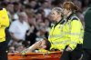 Celtic's Alistair Johnston leaves the field on a stretcher after going down injured against during the UEFA Champions League playoff first leg soccer match at Celtic Park, Wednesday, Aug. 20, 2025, in Glasgow, Scotland. (Andrew Milligan/PA via AP)