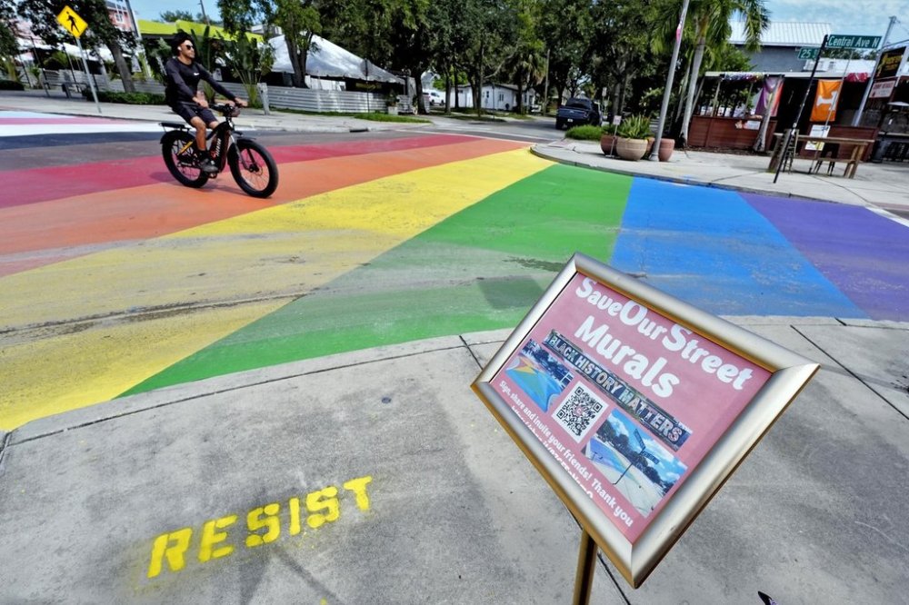 A cyclist crosses a rainbow-painted intersection Wednesday, Aug. 27, 2025, in St. Petersburg, Fla. (AP Photo/Chris O'Meara)