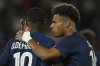 PSG's Desire Doue, right, talks to PSG's Ousmane Dembele during the League One soccer match Paris Saint-Germain against Angers at the Parc des Princes stadium, Friday, Aug. 22, 2025 in Paris. (AP Photo/Aurelien Morissard)