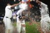Detroit Tigers' Gleyber Torres, center, is dunked by Riley Greene, left, and Spencer Torkelson after drawing a bases-loaded walk to win a baseball game against the Houston Astros in the 10th inning, Tuesday, Aug. 19, 2025, in Detroit. (AP Photo/Ryan Sun)