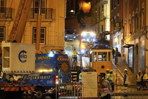 Cranes are positioned to remove the wreckage of a tourist streetcar that derailed and crashed in Lisbon, Thursday, Sept. 4, 2025. (AP Photo/Ana Brigida)