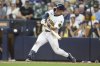 Milwaukee Brewers' Isaac Collins hits a walk-off home run during the ninth inning of a baseball game against the New York Mets, Sunday, Aug.10, 2025, in Milwaukee. (AP Photo/Jeffrey Phelps)