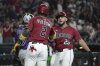 Arizona Diamondbacks' Adrian Del Castillo celebrates with Geraldo Perdomo (2) after hitting a three-run home run against the Colorado Rockies in the first inning of a baseball game, Sunday, Aug 10, 2025, in Phoenix. (AP Photo/Rick Scuteri)
