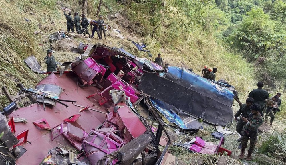 Soldiers and rescue workers stand by the debris of a passenger bus after it plunged into a precipice in Wellawaya, Sri Lanka, Friday, Sept. 5, 2025. (AP Photo/Prasanna Pathmasiri)