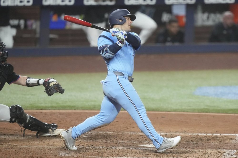 Toronto Blue Jays' Daulton Varsho hits a two-run home run during the sixth inning of a baseball game against the Miami Marlins, Friday, Aug. 22, 2025, in Miami. (AP Photo/Marta Lavandier)