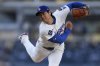 Los Angeles Dodgers starting pitcher Shohei Ohtani works against a Cincinnati Reds batter during the first inning of a baseball game Wednesday, Aug. 27, 2025, in Los Angeles. (AP Photo/Mark J. Terrill)