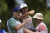 Scottie Scheffler, right, talks with his caddie, Brad Payne, on the fifth tee during the final round of the St. Jude Championship golf tournament Sunday, Aug. 10, 2025, in Memphis, Tenn. (AP Photo/George Walker IV)