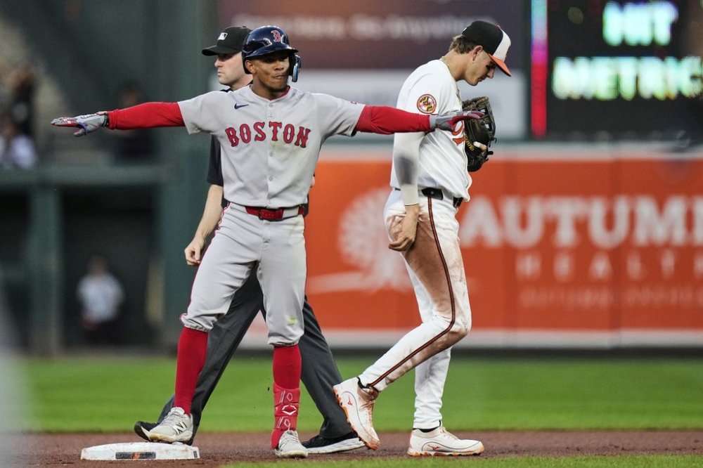 Boston Red Sox's Ceddanne Rafaela, left, celebrates after hitting a double during the fourth inning of a baseball game against the Baltimore Orioles, Wednesday, Aug. 27, 2025, in Baltimore. (AP Photo/Stephanie Scarbrough)