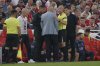 Liverpool's manager Arne Slot, centre, talks to the referee during the English Premier League soccer match between Liverpool and Bournemouth at Anfield stadium in Liverpool, England, Friday, Aug. 15, 2025. (AP Photo/Ian Hodgson)