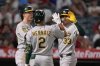 Athletics' JJ Bleday, right, is congratulated by Zack Gelof, left, and Darell Hernaiz after hitting a three-run home run during the third inning of a baseball against the Los Angeles Angels, game Friday, Sept. 5, 2025, in Anaheim, Calif. (AP Photo/Mark J. Terrill)